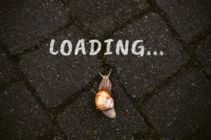 Loading, downloading, slow internet speed concept with word loading and Brown garden snail crawling