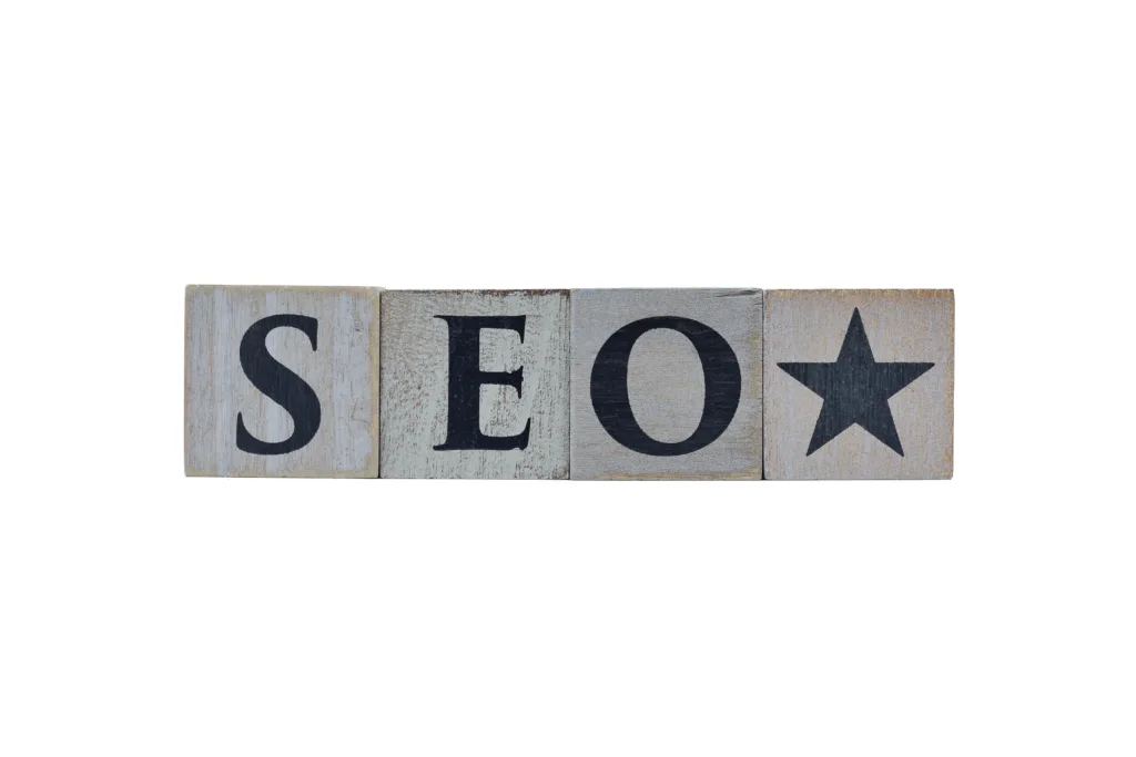 Wooden cubes showing the letters SEO (Search Engine Optimization) and star icon on white background