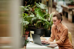 Young contemporary female owner of small business working in the internet