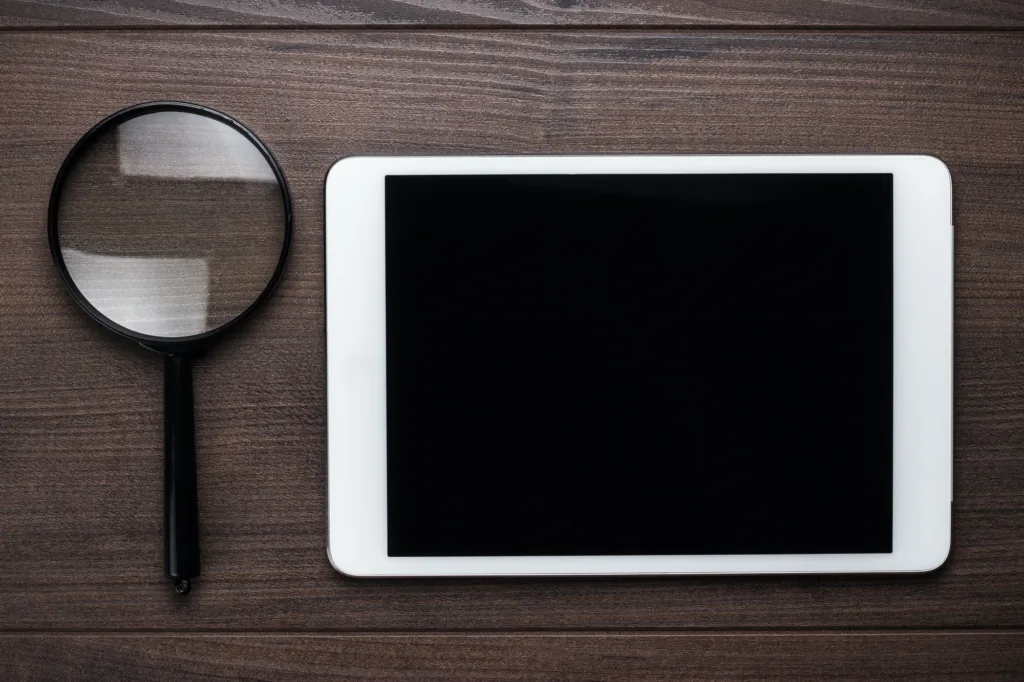 Magnifying Glass And Tablet Computer