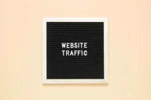 The phrase website traffic on black letter board over isolated beige background