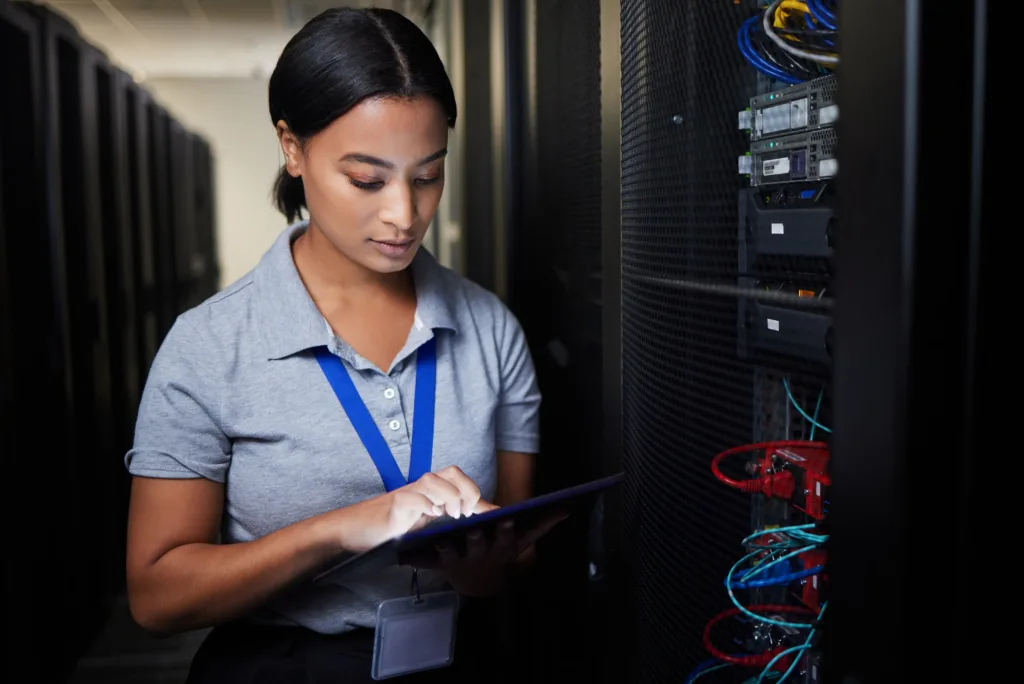 Woman, tablet and server room, programming or coding for cybersecurity, information technology or d